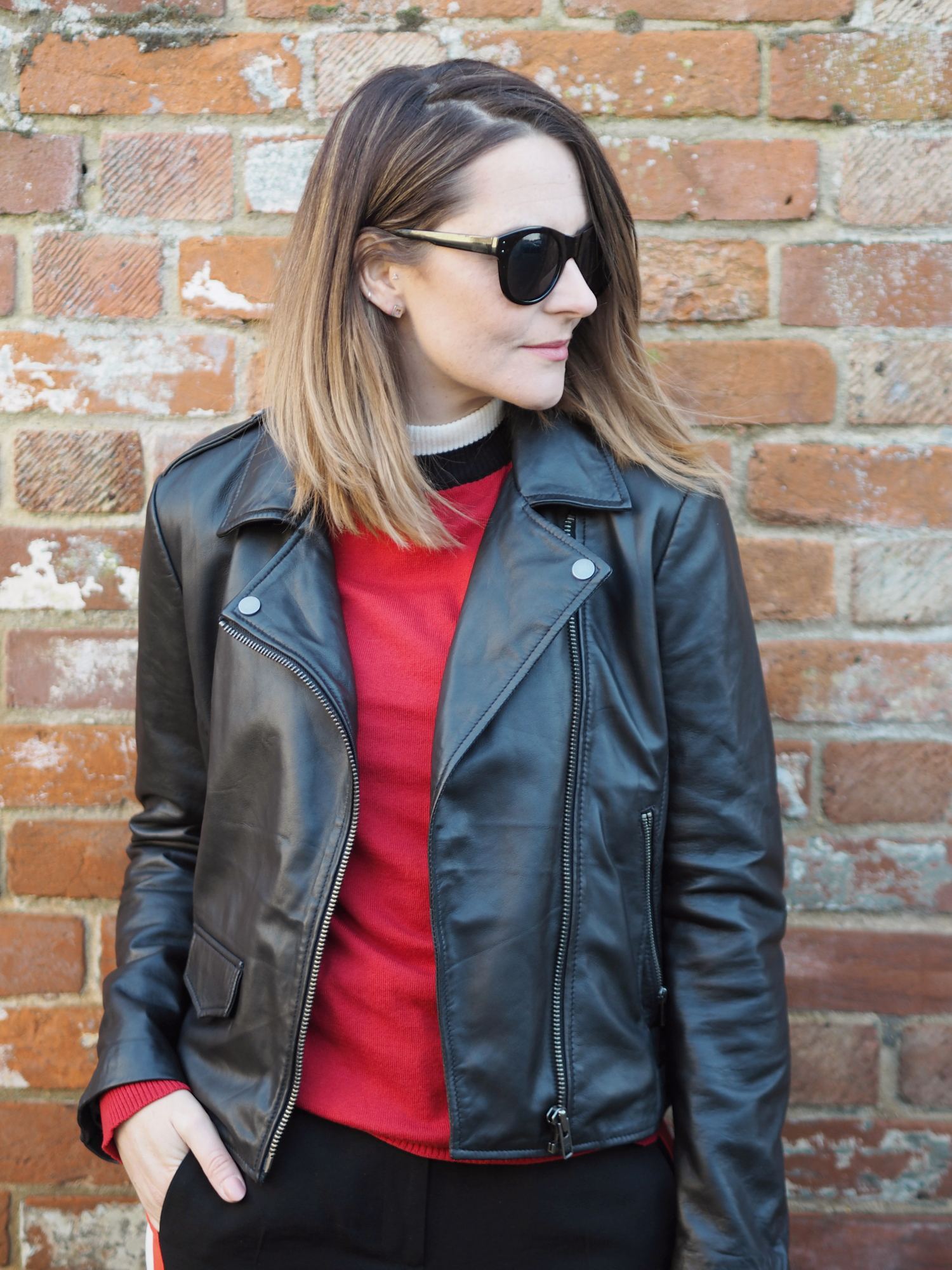 sporty striped outfit black biker jacket and red jumper