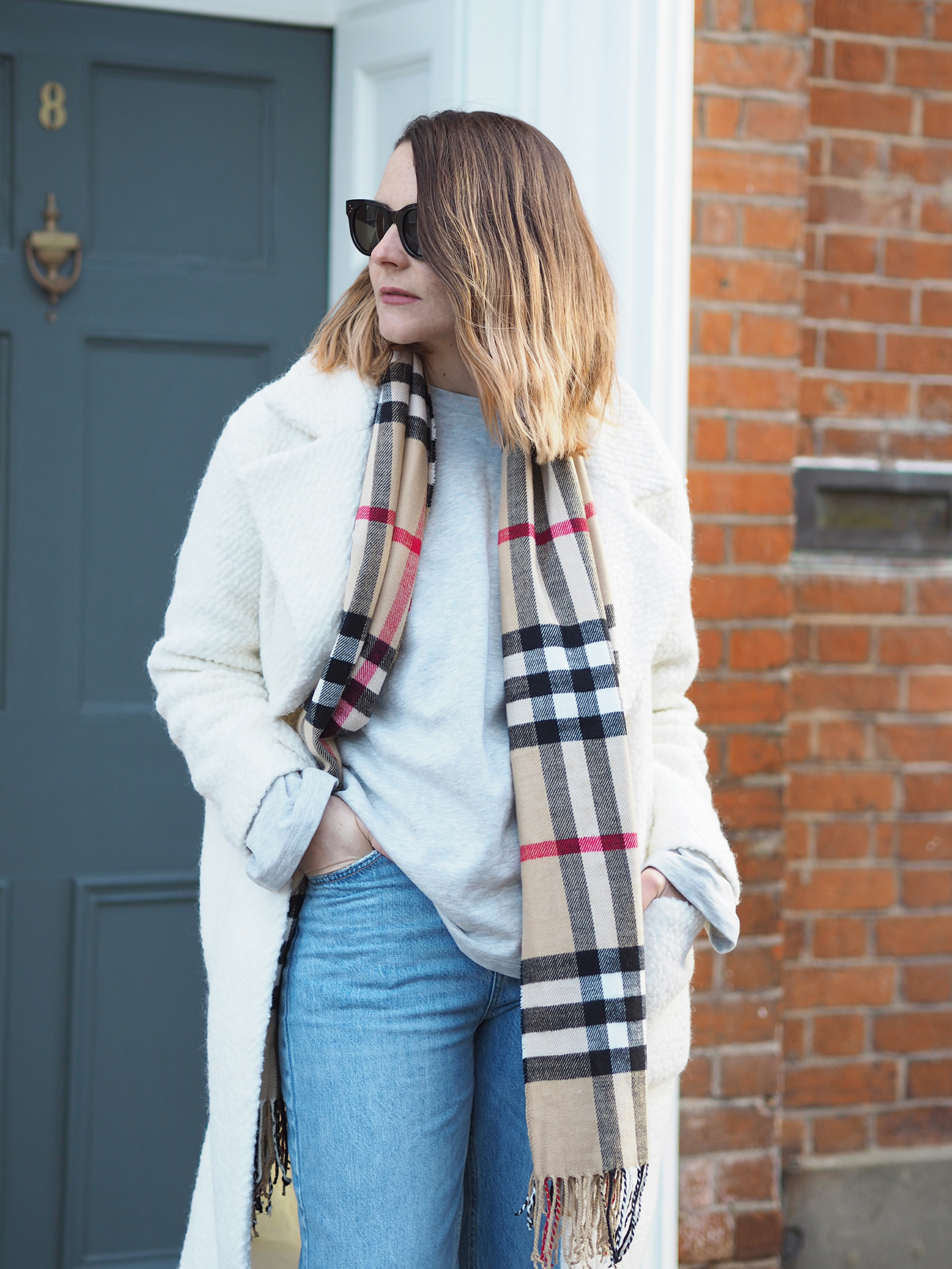 cream coat and burberry scarf outfit with jeans