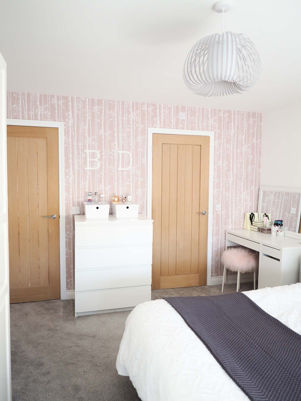 grey and pink bedroom with pink wallpaper
